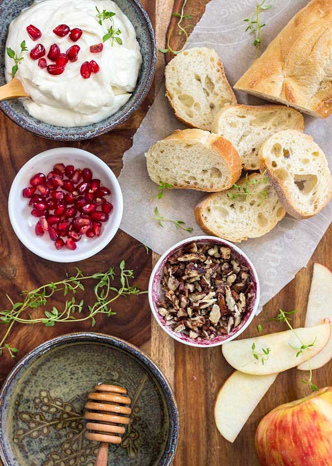 Bowls of the different toppings for goat cheese burschetta.