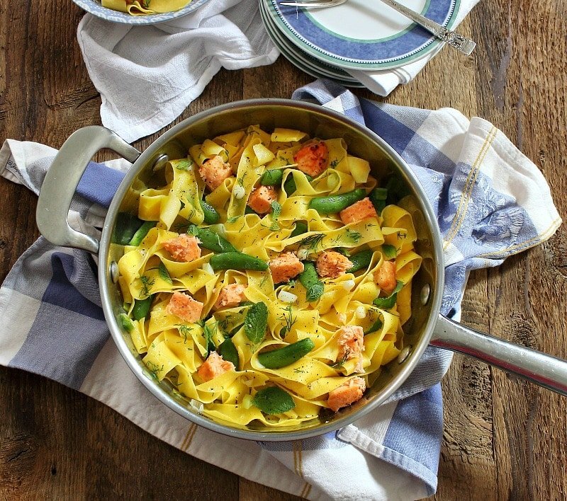 Pappardelle with salmon and sugar snap peas in a large bowl