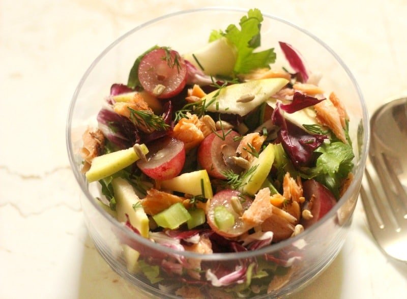 Autumn salad with apple and smoked salmon in a bowl